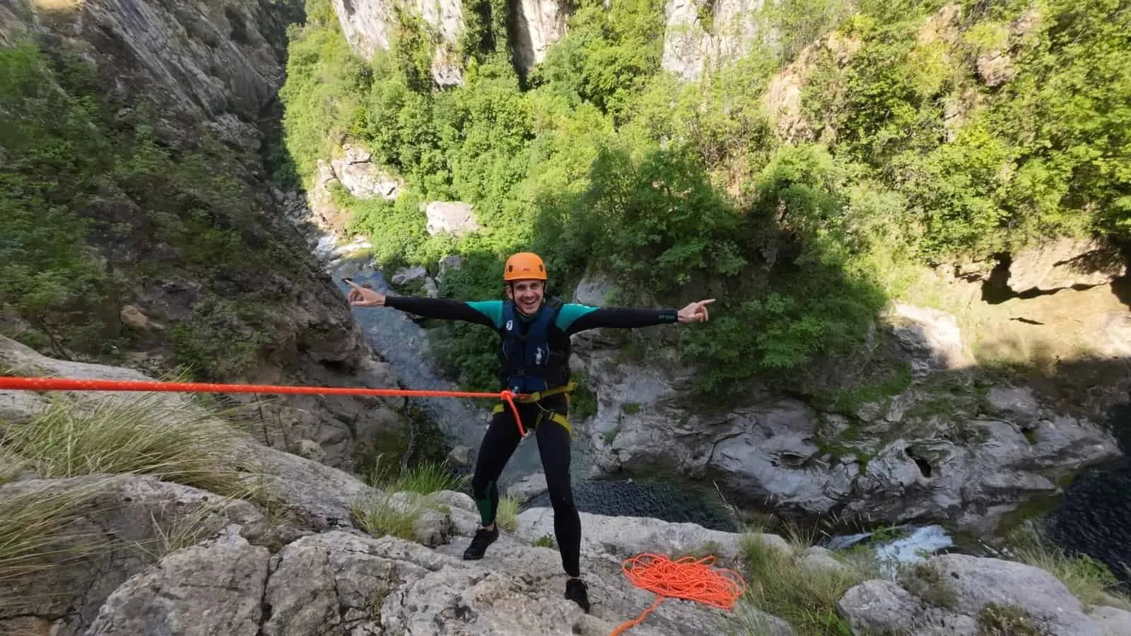 A canyoning guide on the rope at the top of the Gubavica descent